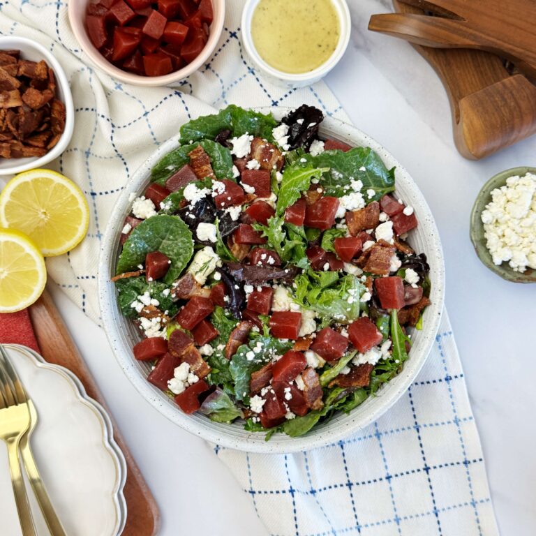 A white salad bowl with Paisley Farm Sweet Pickled Beets and Bacon Salad with Lemon Vinaigrette