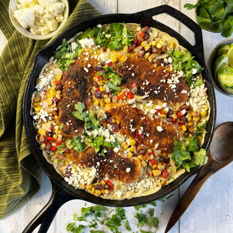 One pan creamy chicken and cowboy caviar in a cast iron skillet.