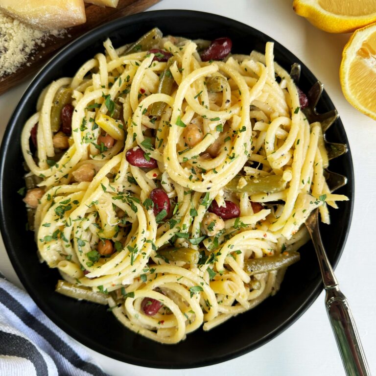A black bowl of Creamy Lemon Pasta with Five Bean Salad