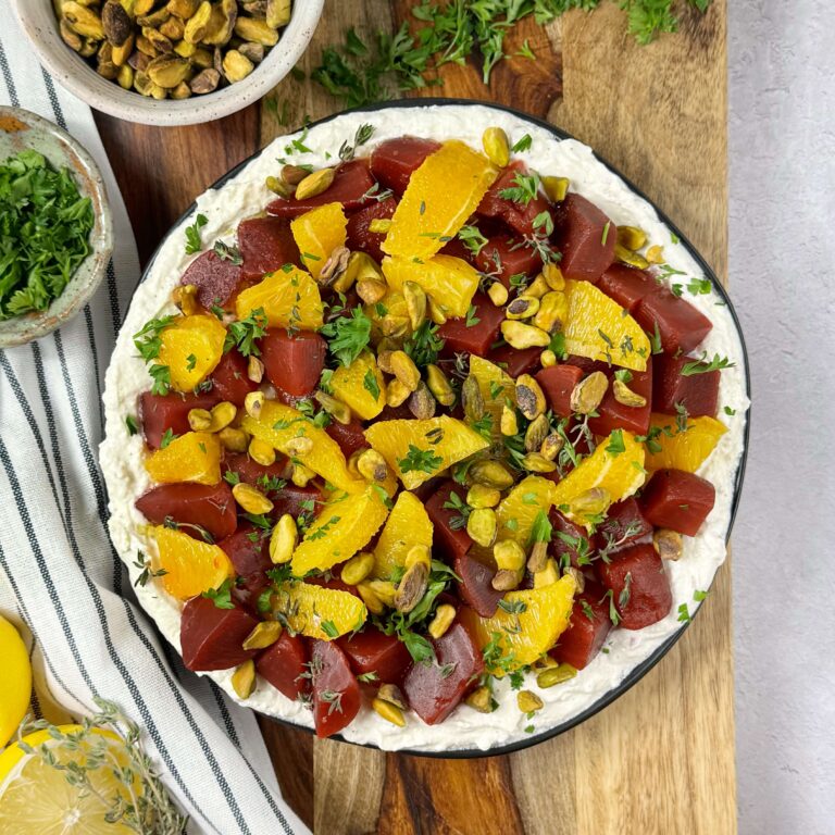 A white bowl of Orange and Sweet Beet Salad Over Whipped Feta
