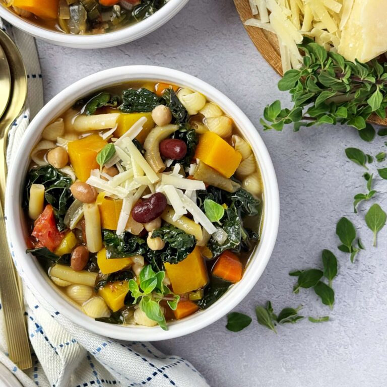 A white bowl of Autumn Vegetable Soup with Five Bean Salad