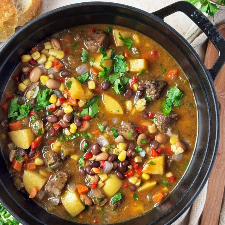 A black pot filled with Beef Stew and Cowboy Caviar.