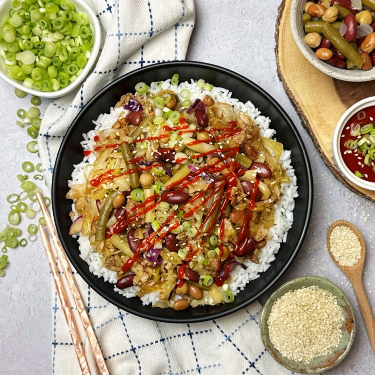 A dinner plate with Eggroll Bowl with Cabbage and Five Bean Salad.