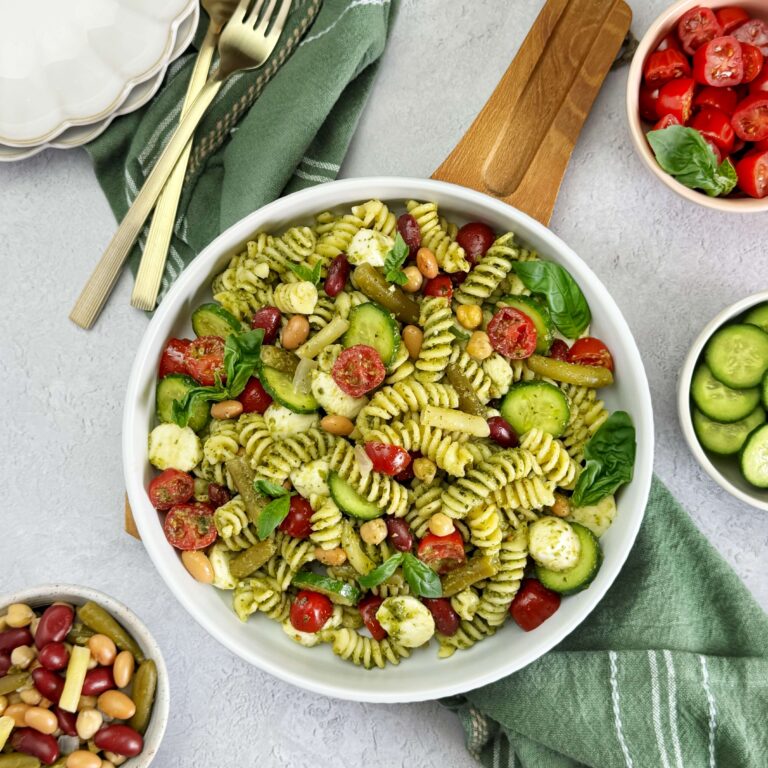A white dinner bowl with Bean Salad Pesto Pasta Salad
