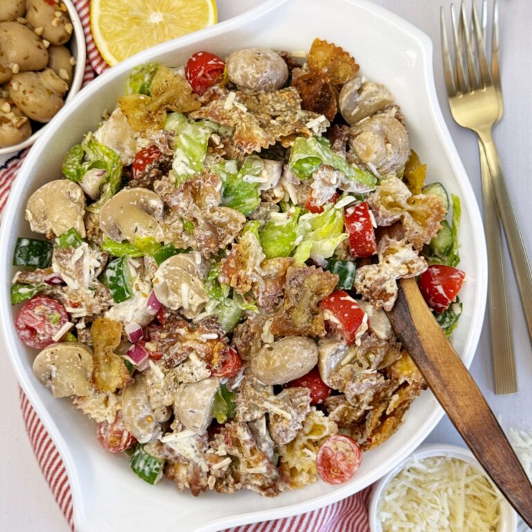 Viral crispy pasta salad with marinated mushrooms, fresh vegetables, and tangy yogurt dressing served in a bowl for a crunchy, flavorful side dish.